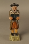 Painted wooden figure of a Jewish man praying and holding a book