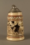 Black and cream ceramic beer stein with Jewish usurers tormenting a German farmer