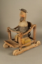 Hand crafted wooden pull toy of a Jewish man praying
