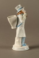 2016.184.589.1 right side
White porcelain match holder depicting a stereotypical Jewish peddler

Click to enlarge