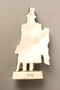 Porcelain figurine of a Jewish ribbon peddler in a green coat