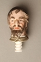 Porcelain bottle stopper with a painted finial depicting a Jewish stereotype