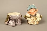 2016.184.620_a-b open
Ceramic cookie jar of a Jewish man kneeling with 2 money bags

Click to enlarge