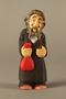 Wooden figure of a Jewish man holding a money bag and coin