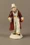 White porcelain figurine of a Jewish money changer in a gold striped vest