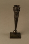 Dark bronze candlestick in the shape of a happy Jewish speculator