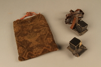 2006.516.4 a-c front
Pair of Tefillin and pouch owned by a Romanian Jewish concentration camp survivor

Click to enlarge