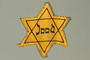 Star of David badge printed with Jood worn by a Dutch Jewish girl