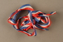 Red white and blue ribbon with the ends tied together given to former Vice President Henry A. Wallace by female French partisans