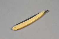 2017.263.5 a side a
Straight razor with yellow plastic handle

Click to enlarge