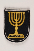 1992.169.11_a front
Betar patch with an embroidered menorah worn by an internee at a displaced persons camp

Click to enlarge