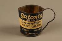 2018.426.9 side a
Pitcher made from an Eatonia Brand butter can and used by an American internee

Click to enlarge