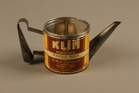 2018.426.10 a side a
Kettle made from a can of Klim powdered milk and used by an American internee

Click to enlarge