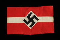 1993.151.1 front
Nazi armband with white stripe and swastika taken from the body of a dead German soldier by an American soldier

Click to enlarge