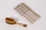 Child's hairbrush and plaid handkerchief used by a young Jewish Polish refugee