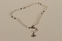 White bead rosary on a chain with a cross