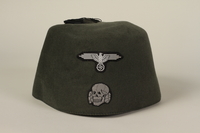 1994.101.2 front
Waffen SS green fez found in Dachau by a US soldier

Click to enlarge