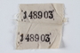 White cloth badge with 2 stencilled prisoner numbers retrieved by a US soldier