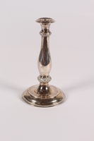 2013.476.3 front
Silver floral embossed candlestick acquired by a former Kindertransport refugee

Click to enlarge