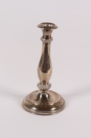 2013.476.4 front
Silver floral embossed candlestick acquired by a former Kindertransport refugee

Click to enlarge